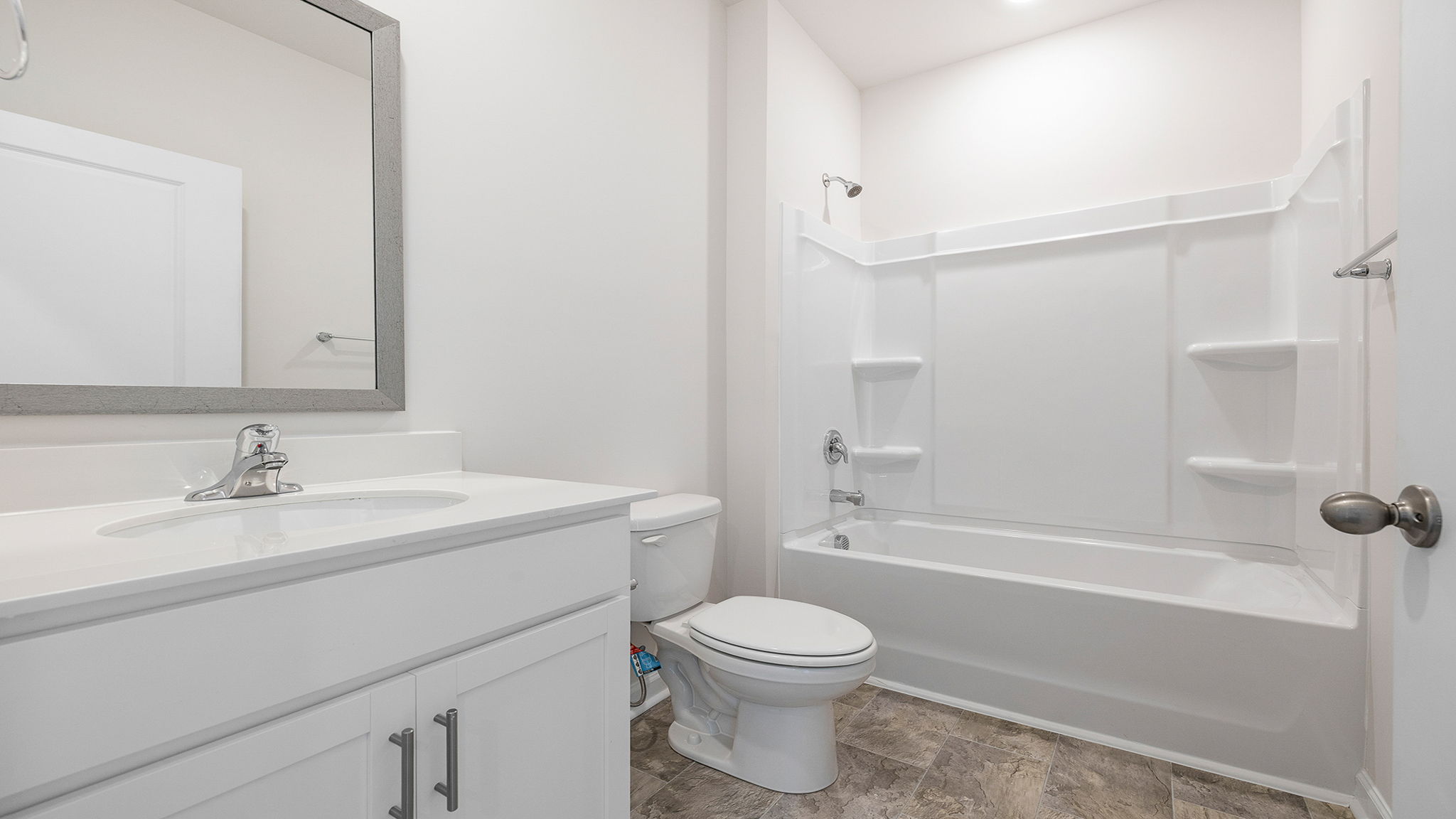 Hall bathroom with vanity and combination shower / tub.