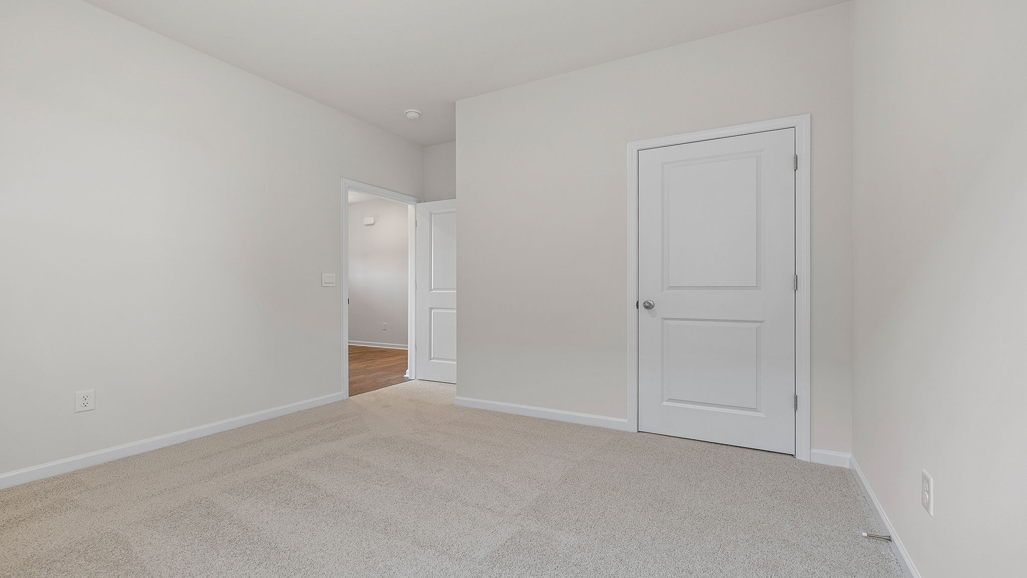 Bedroom with window and carpet.