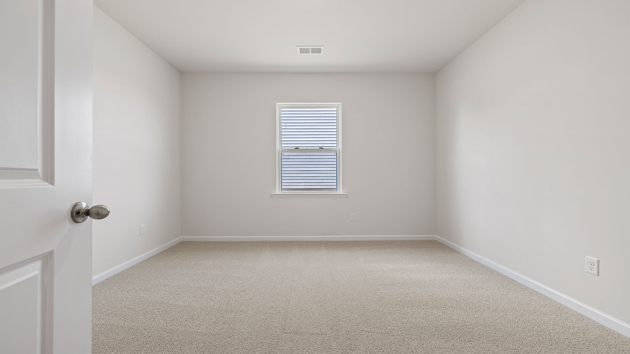 Bedroom with window and carpet.