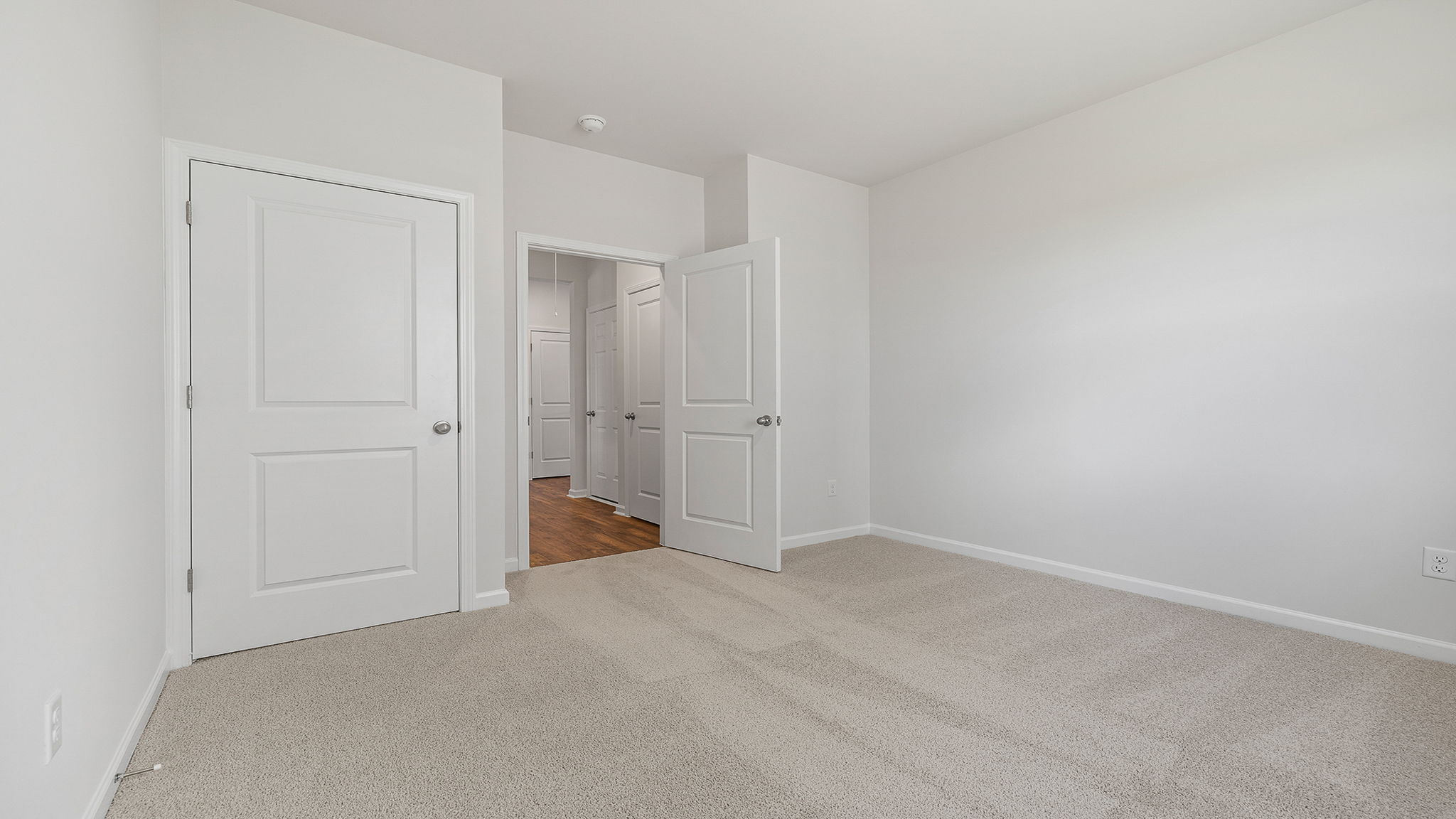 Bedroom with window and carpet.