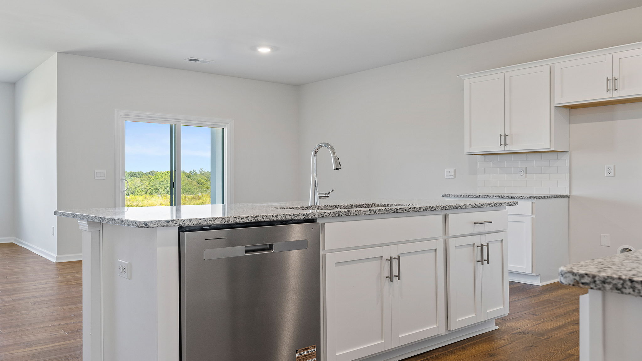 Island overlooks the dining area and hosts the sink and dishwasher.