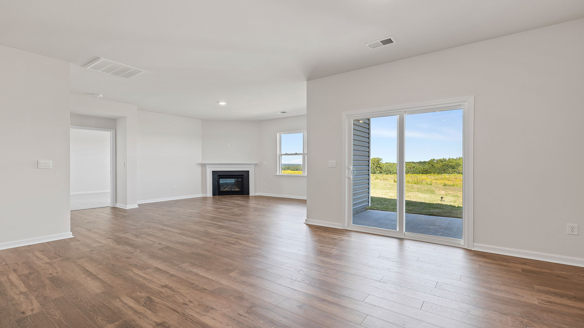 View from dining room of the family room and door to the back  yard.