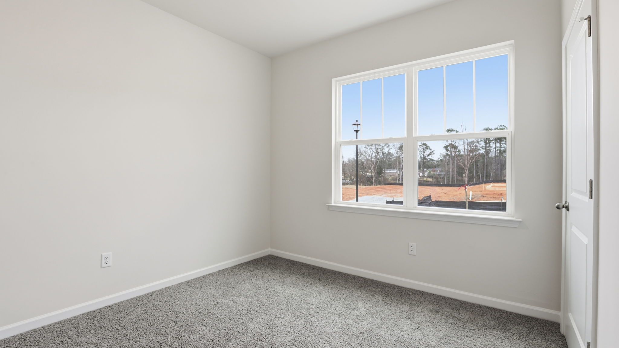 Bedroom with window and carpet.