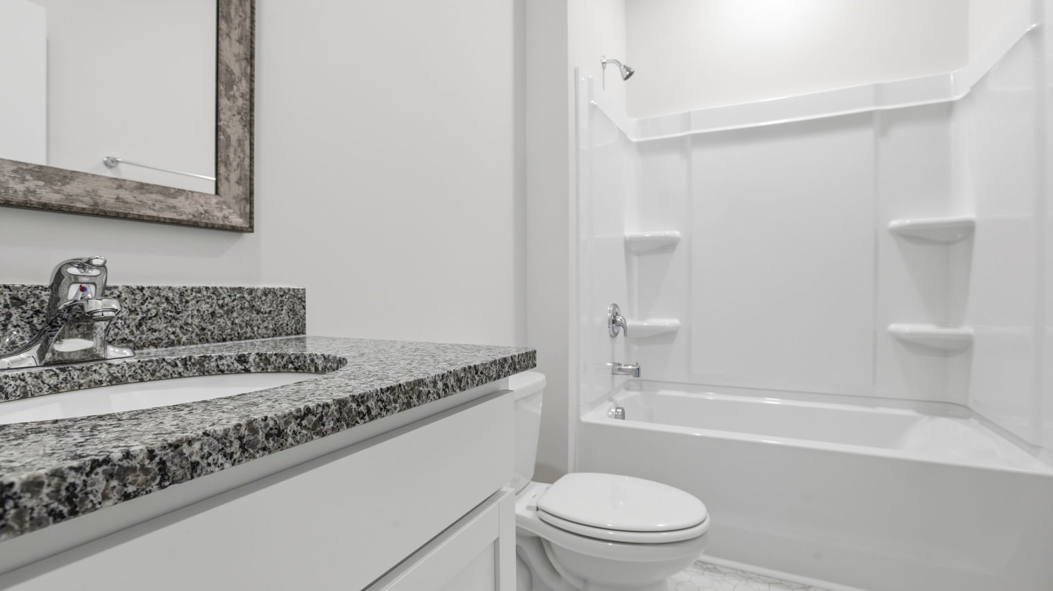 Hall bathroom with vanity and combination shower / tub.