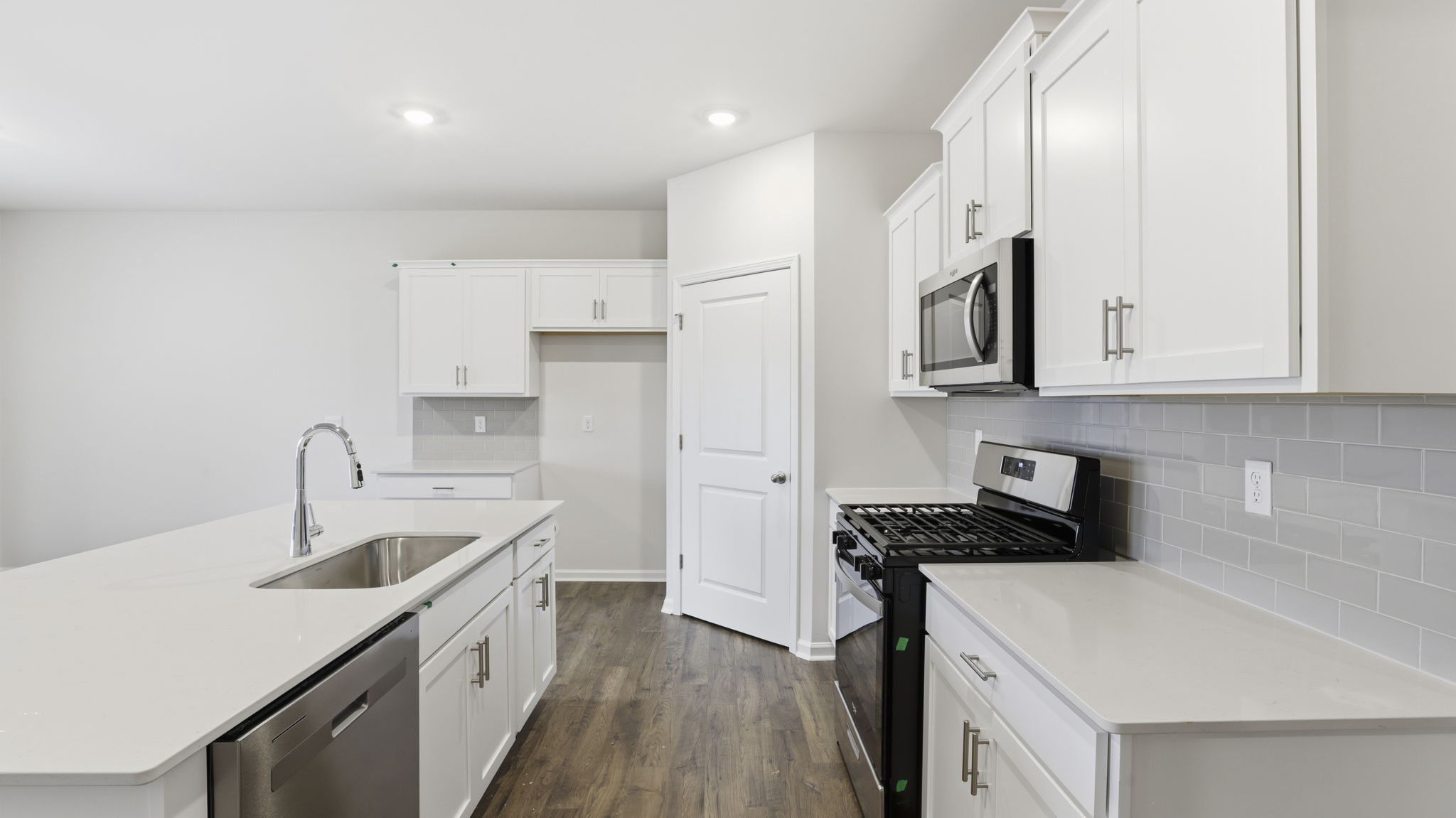 Kitchen and island have quartz countertops.