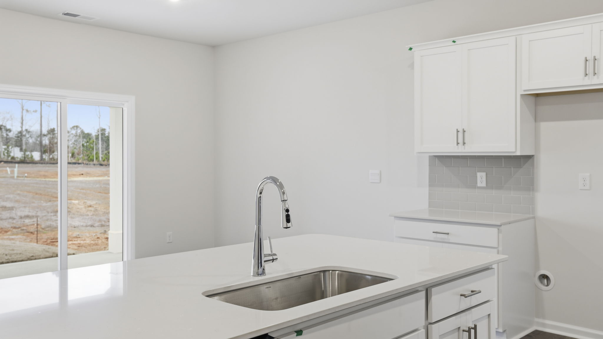 Kitchen island hosts the sink and dishwasher.
