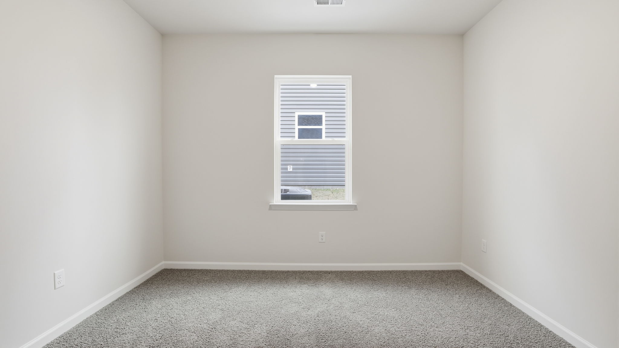 Bedroom with window and carpet.
