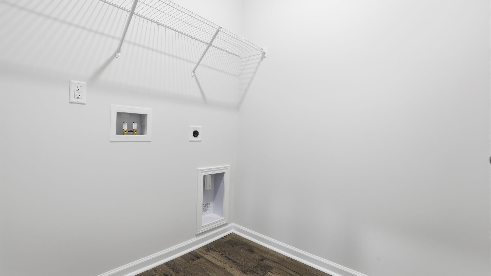 Walk-in laundry room with shelving.