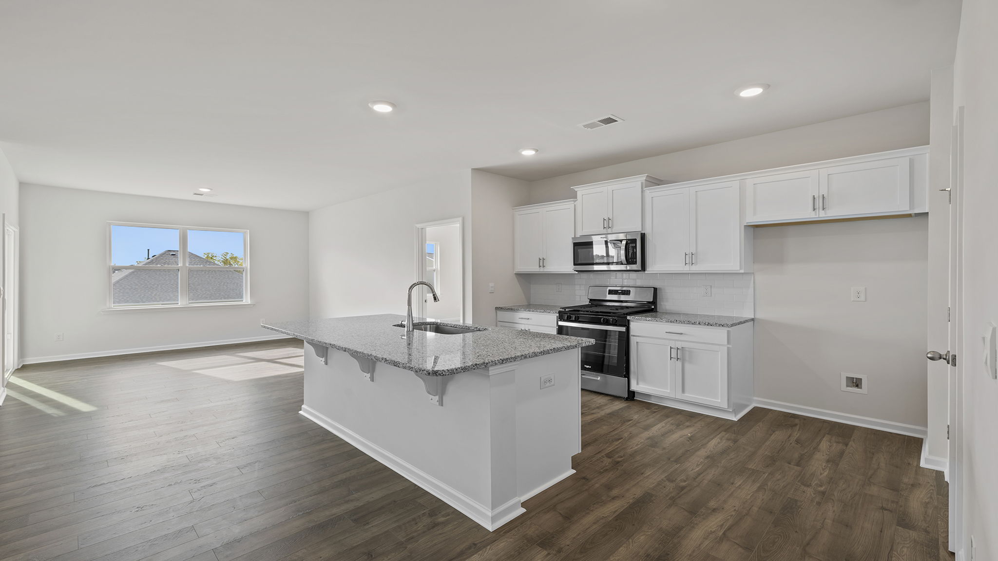 Kitchen with island and cabinets.