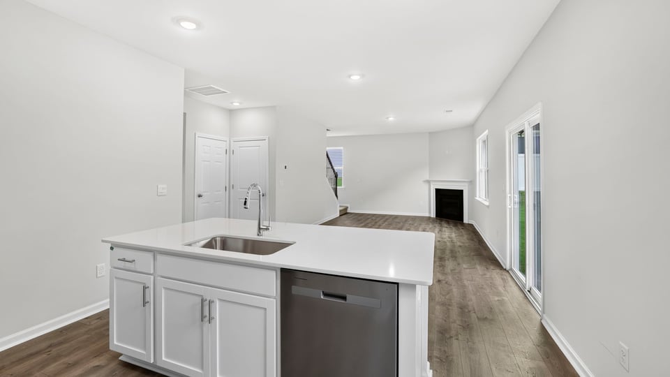 Full view of living area and fireplace from kitchen