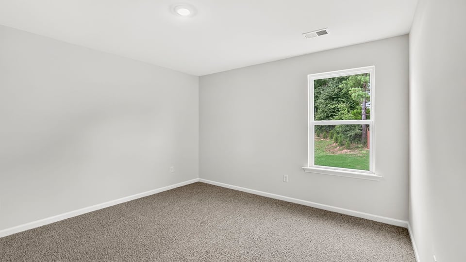 Bedroom with carpet and window