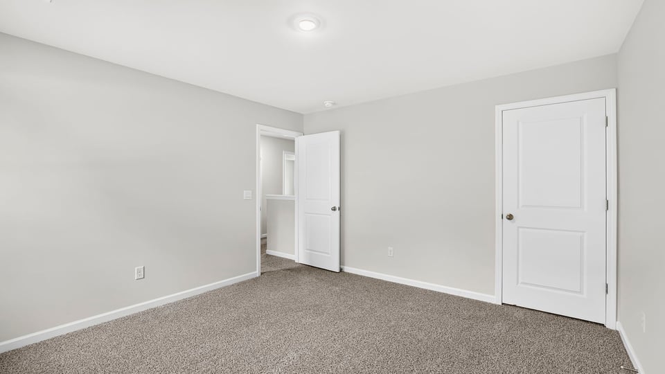 Bedroom with carpet and closet