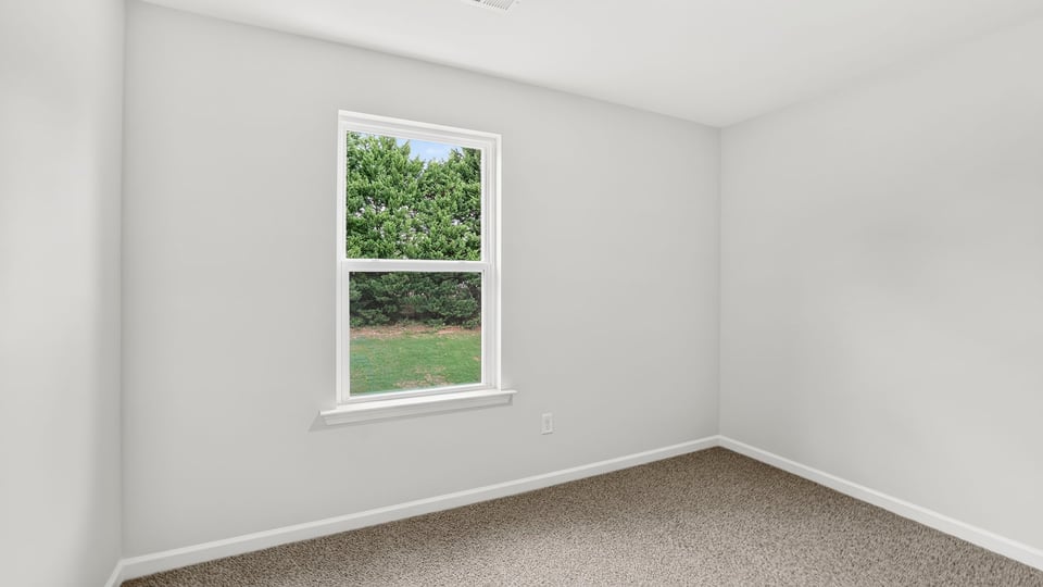 Bedroom with carpet and window