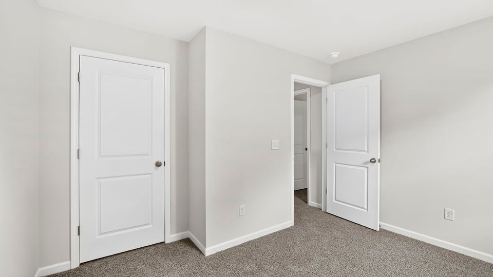 Bedroom with carpet and closet
