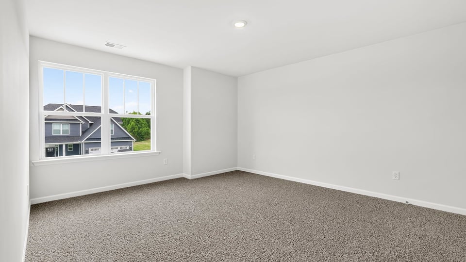 Bedroom with carpet and window
