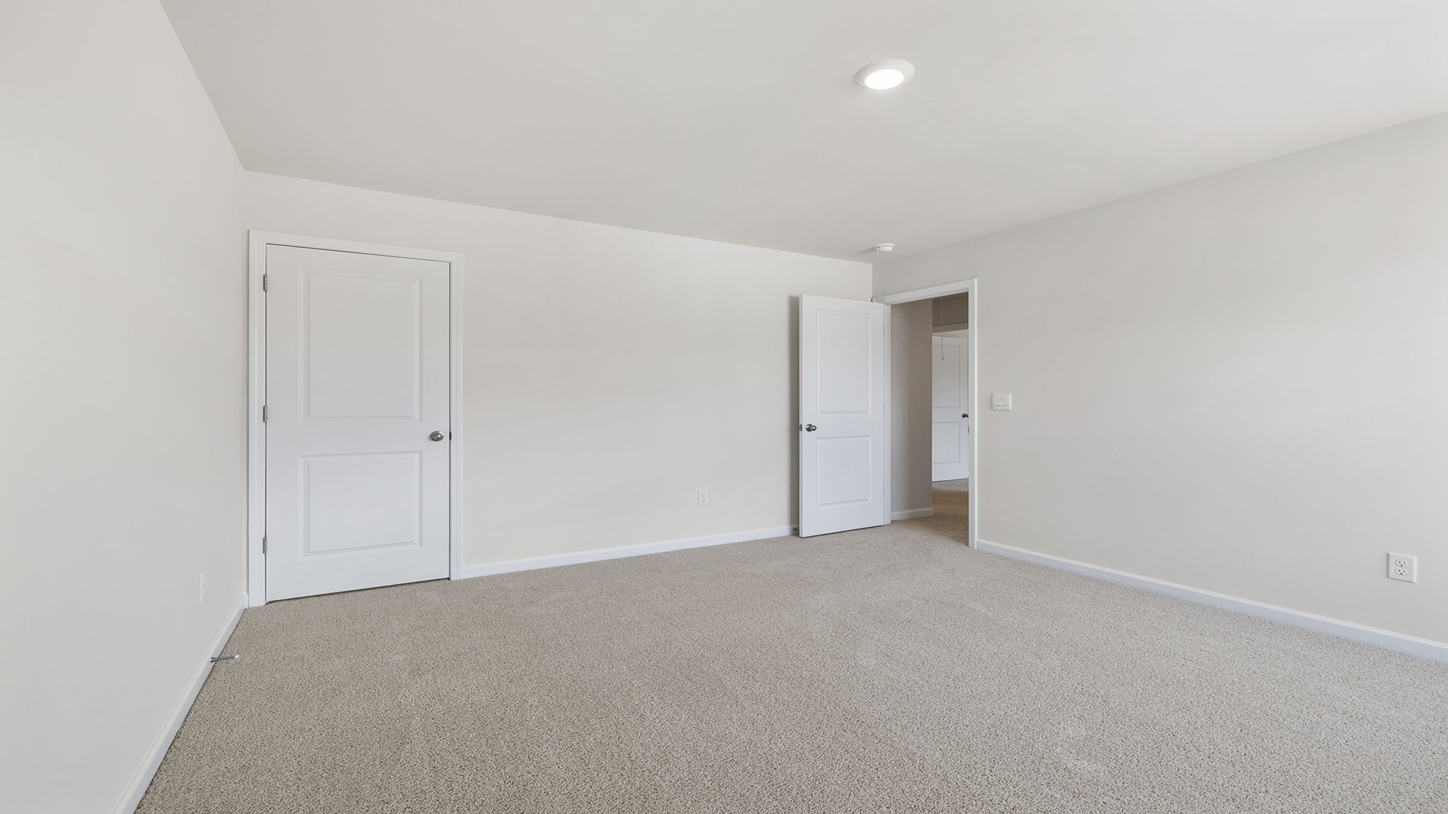 Primary bedroom with carpet.