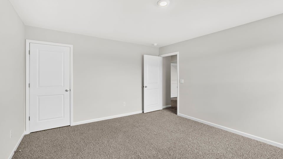 Bedroom with carpet and closet