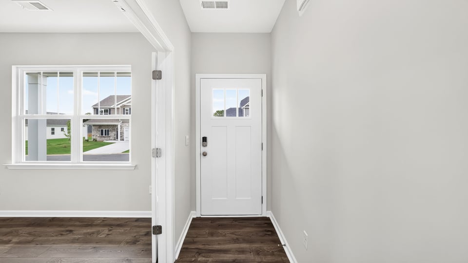 View of front door and office/sunroom window