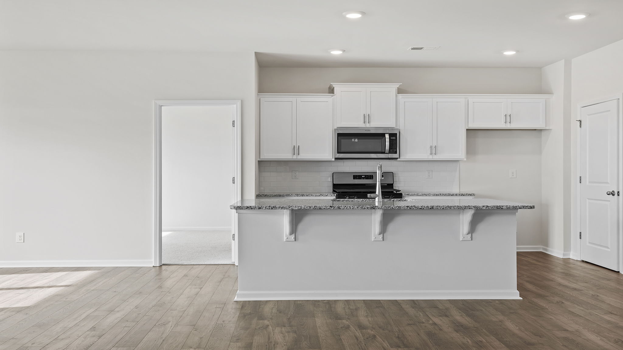 Kitchen with island and cabinets.