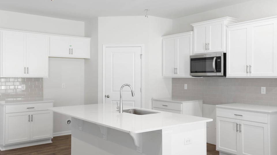 Kitchen and island with quartz countertops.