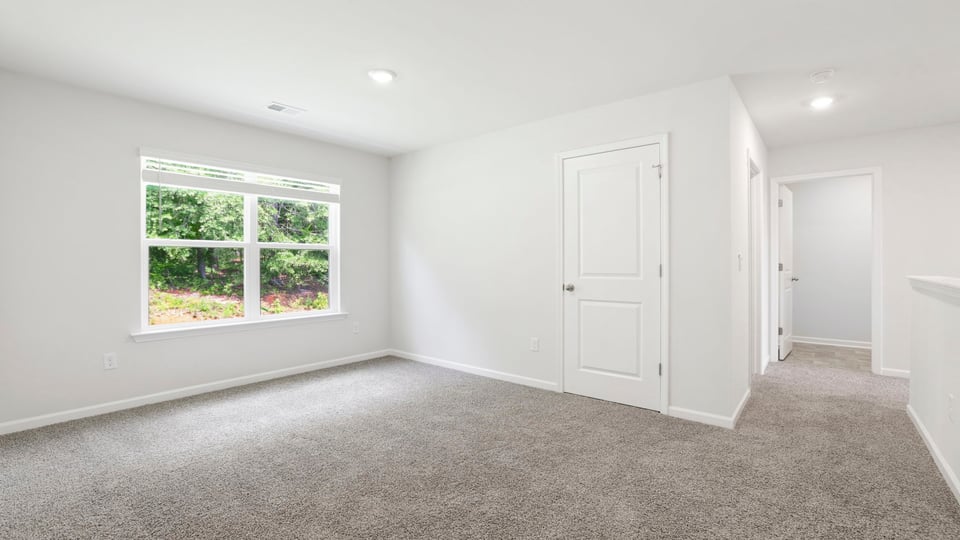 Bedroom with carpet and window.