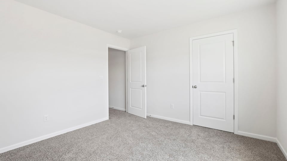 Bedroom with carpet and window.