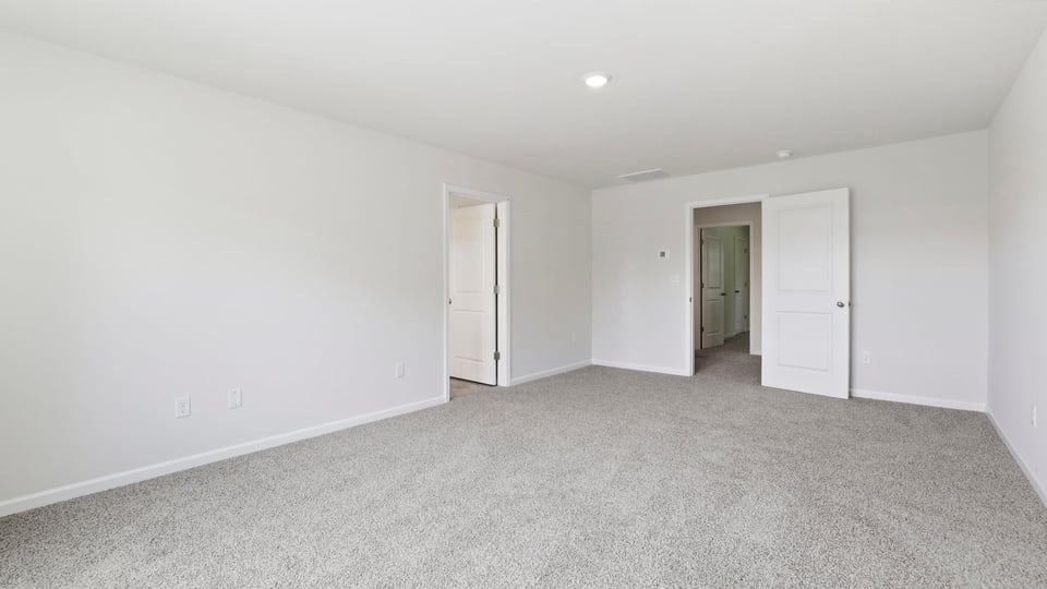 Bedroom with carpet and window.