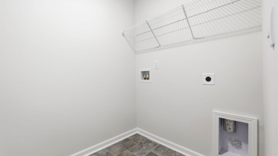 Laundry room with hanging storage racks.