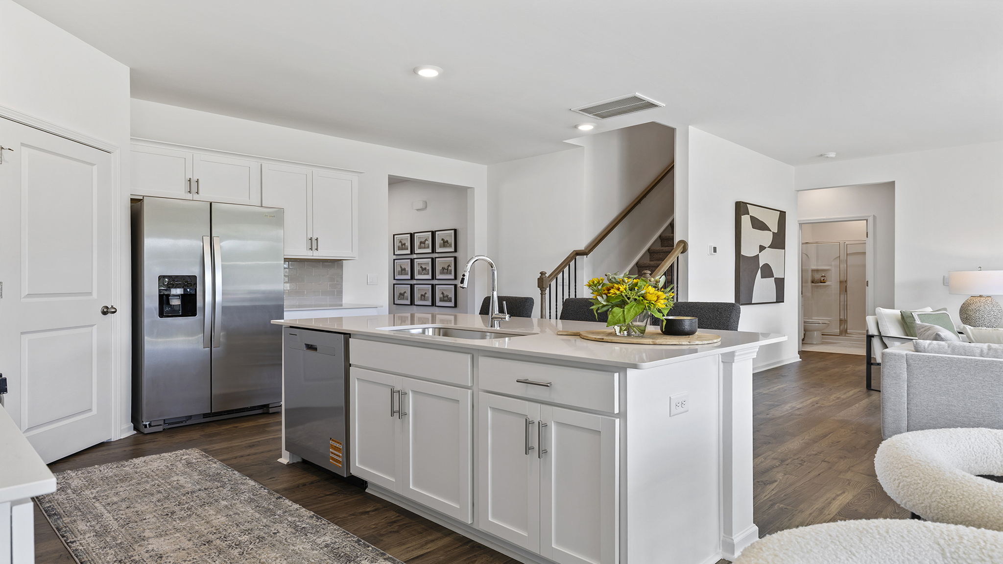 Kitchen and island with quartz countertops and stainless steel appliances.