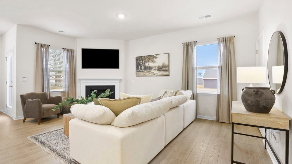 Living room with fireplace and windows.