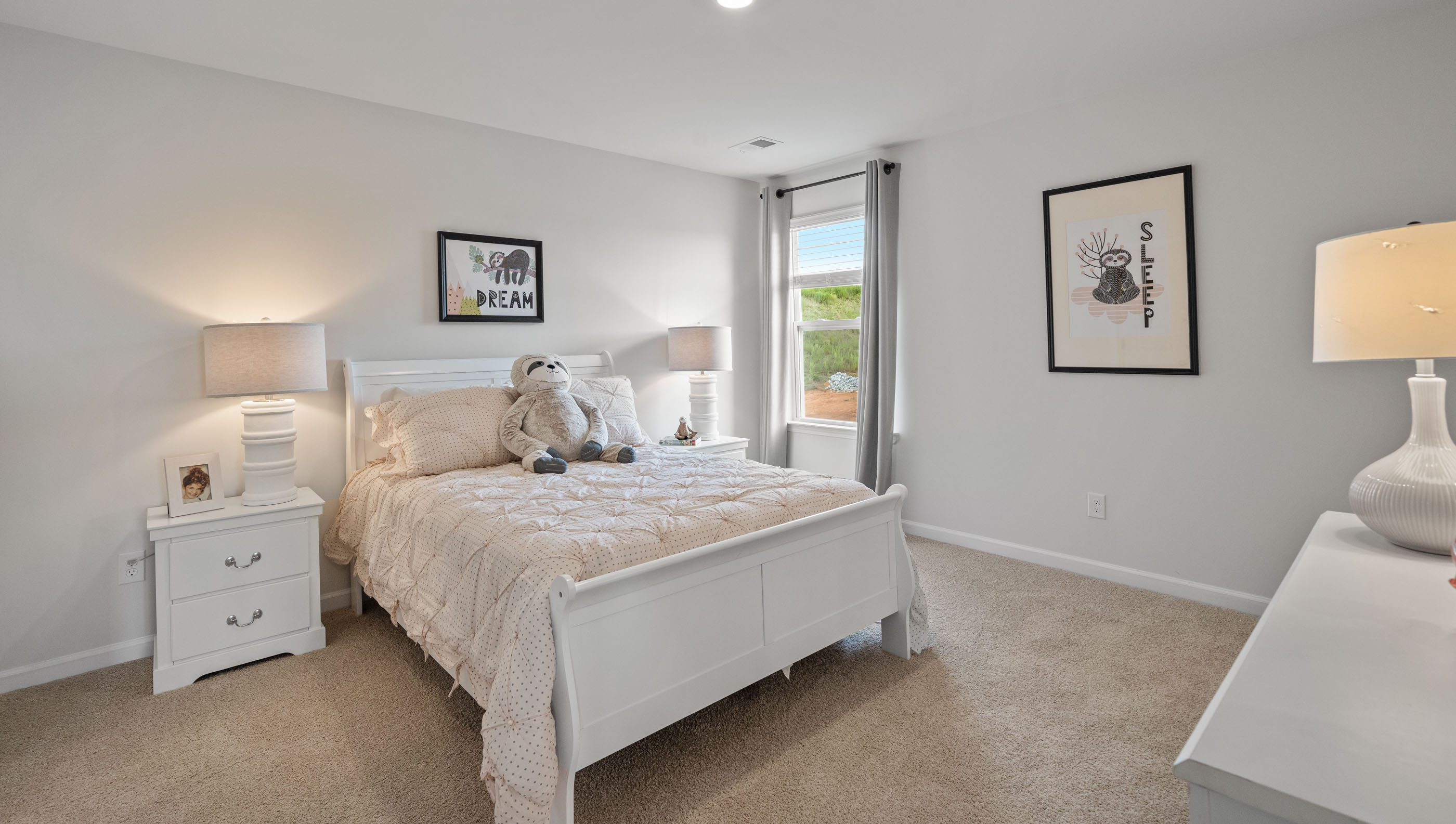 Bedroom with carpet and windows.