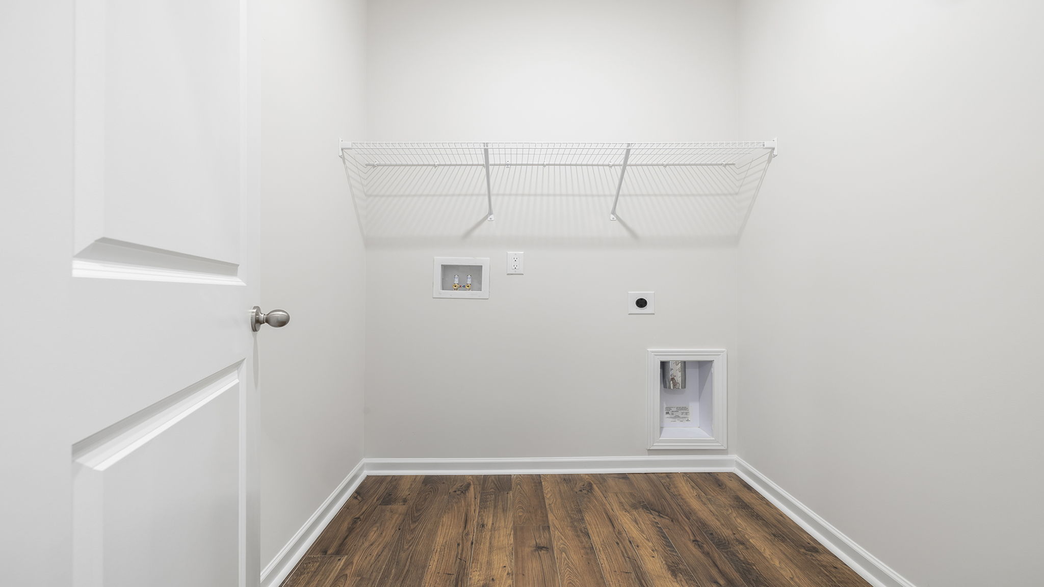 Laundry room with shelf.