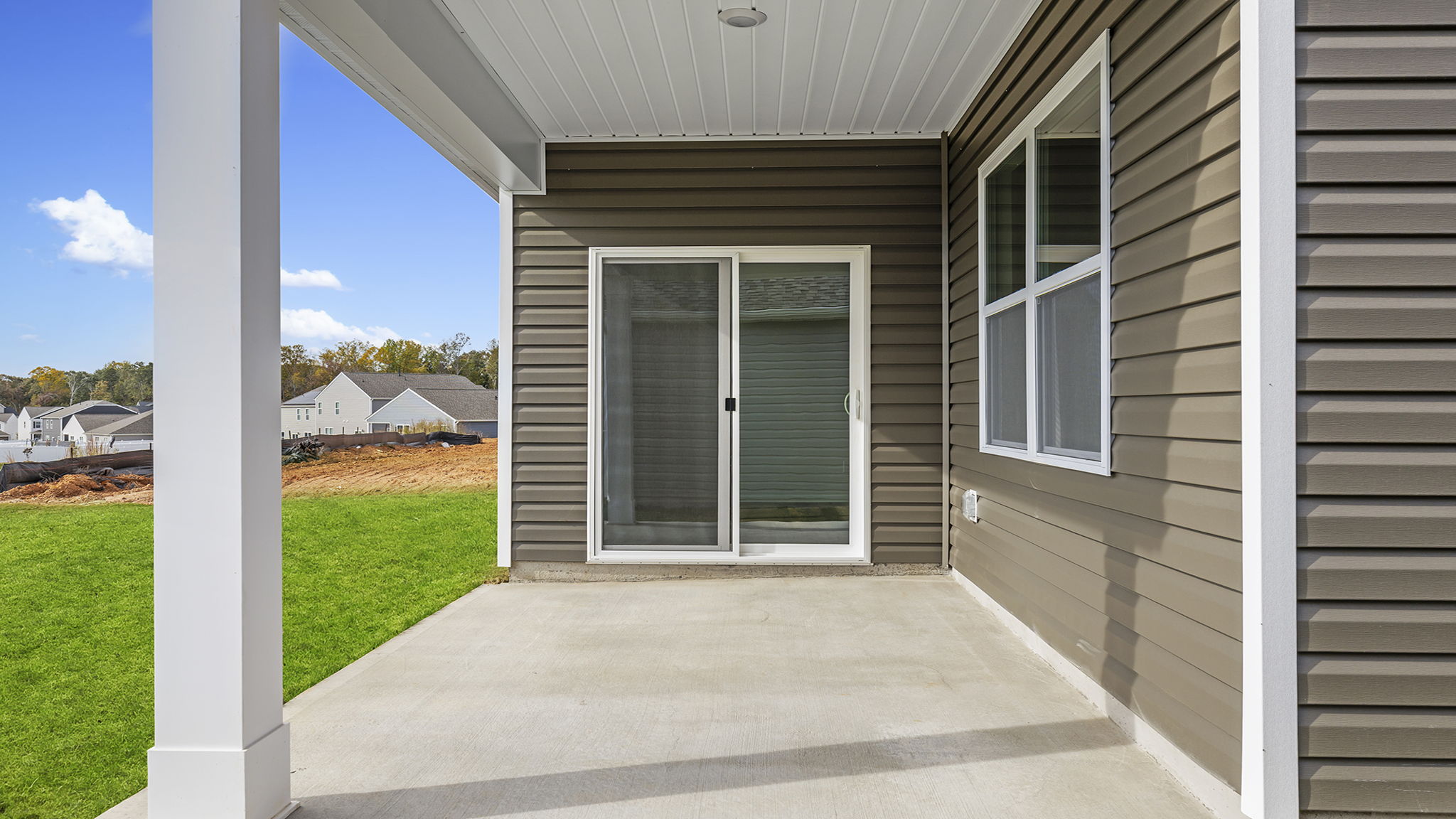 Back exterior with patio and large backyard.