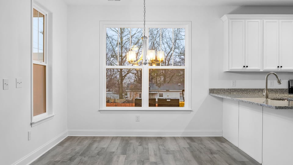 Kitchen with cabinets and window.