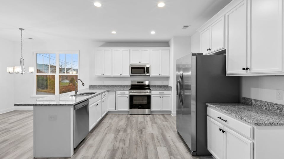 Kitchen with cabinets and window.
