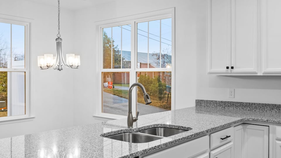Kitchen with cabinets and window.