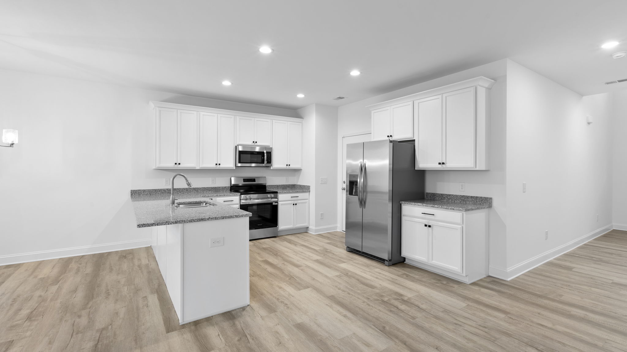 View of kitchen and hallway to the entrance.