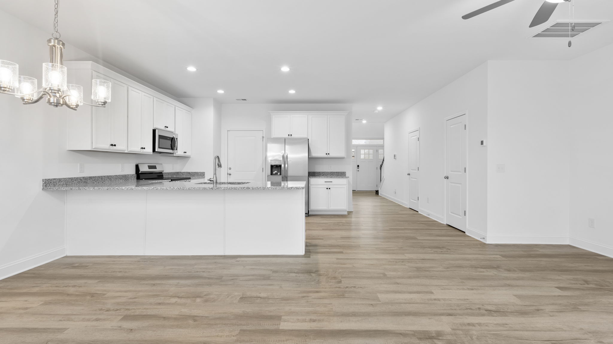 View of open floor plan and hallway to the kitchen.