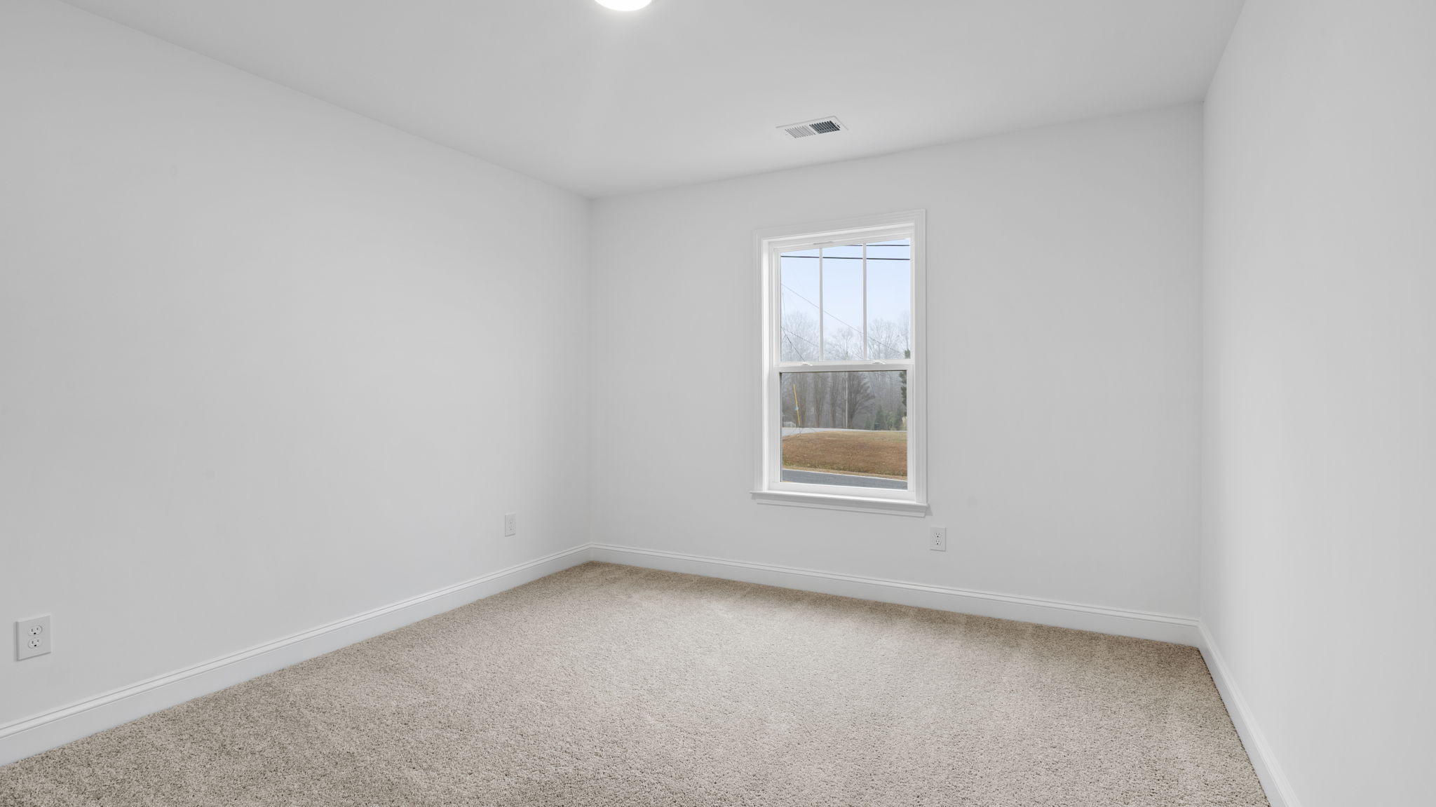 Bedroom with window and carpet.