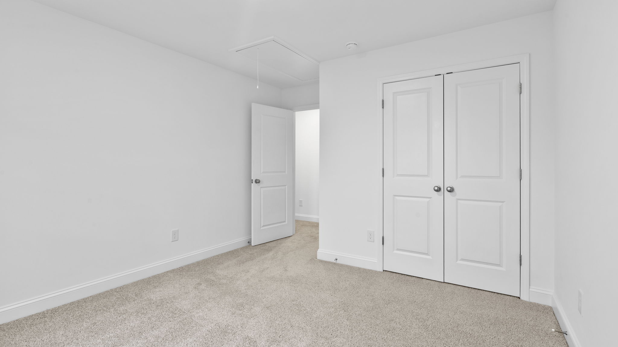 Bedroom with window and carpet.