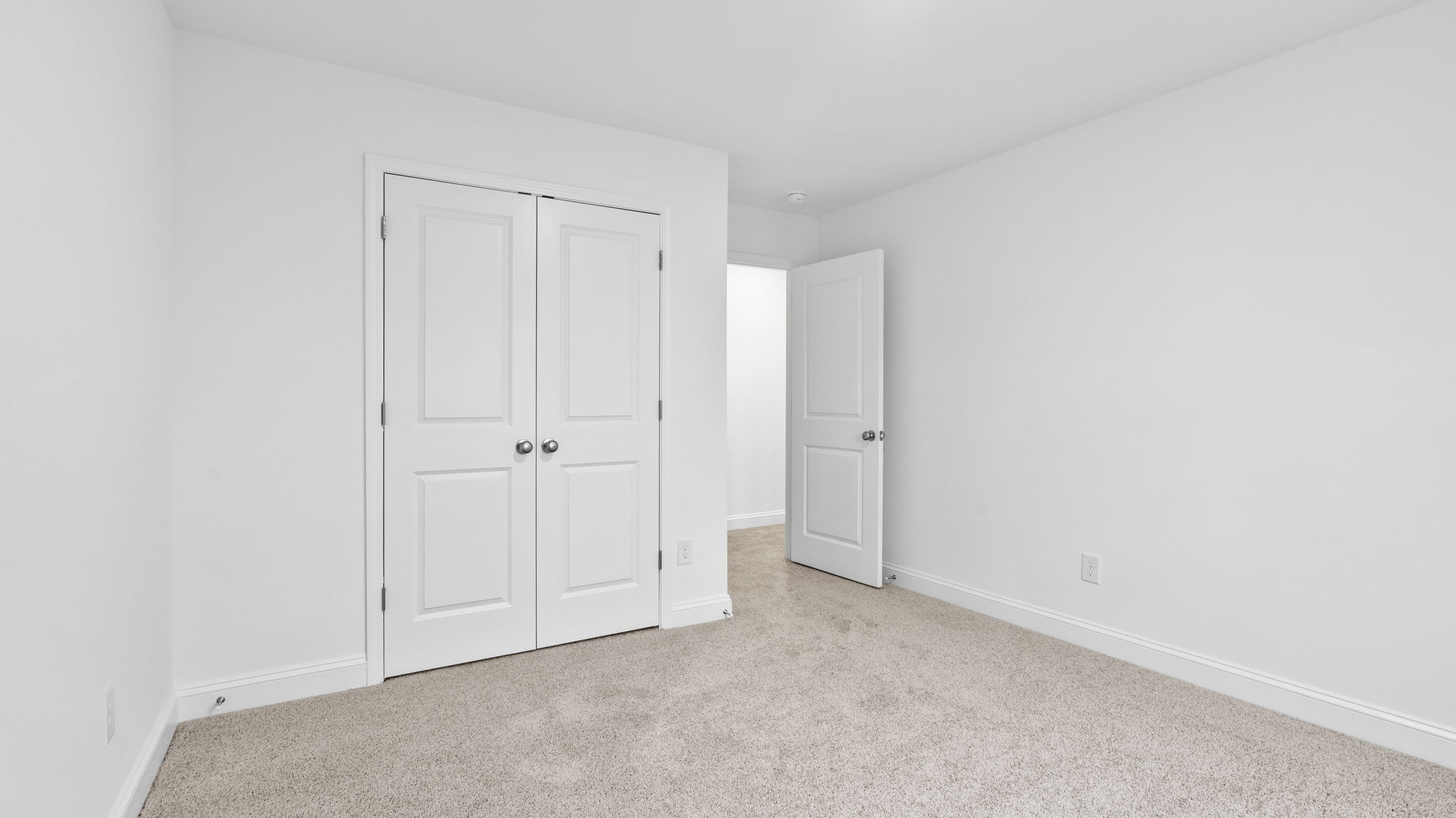 Bedroom with window and carpet.