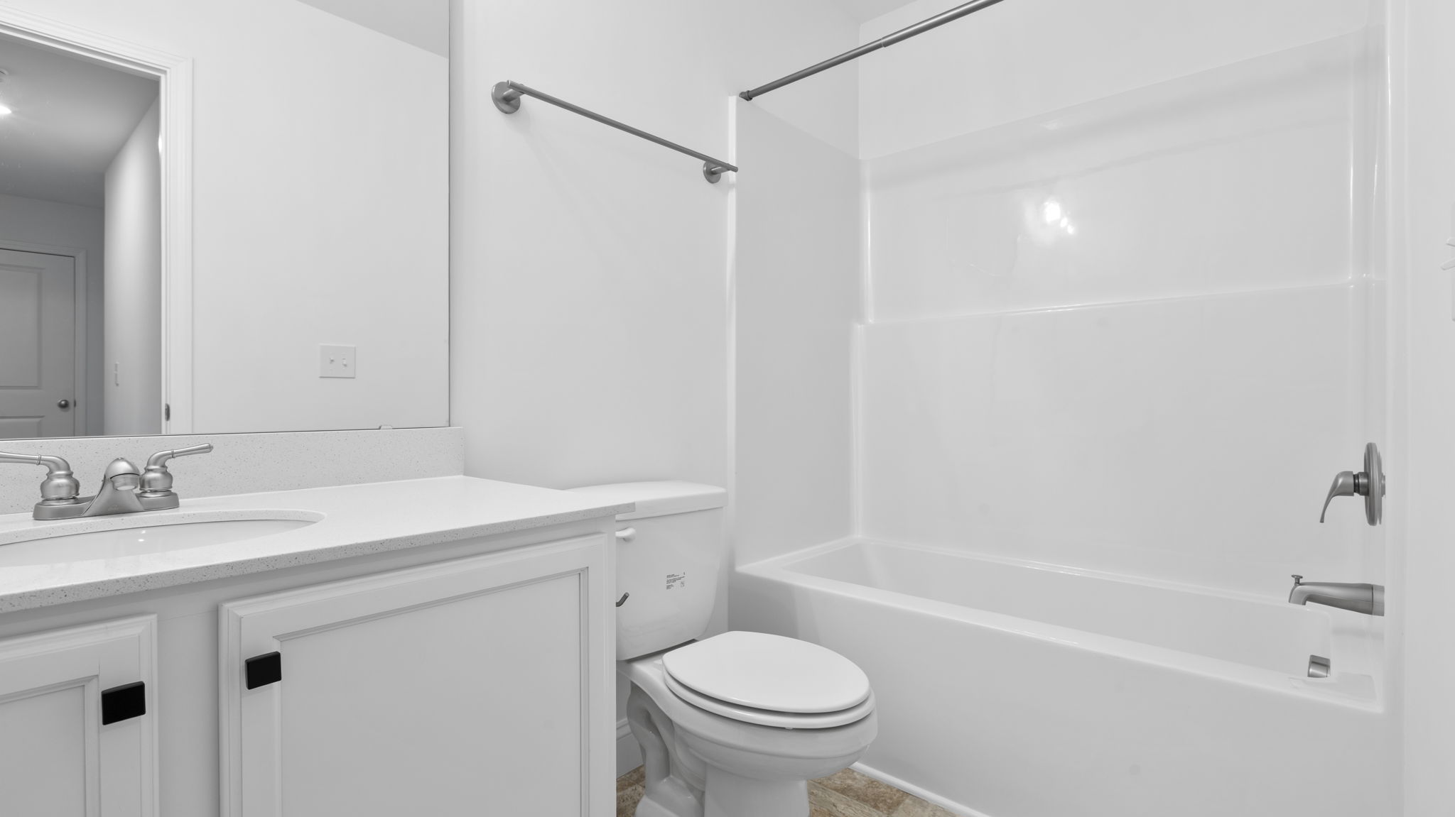 Hall bathroom with vanity and combination shower / tub.