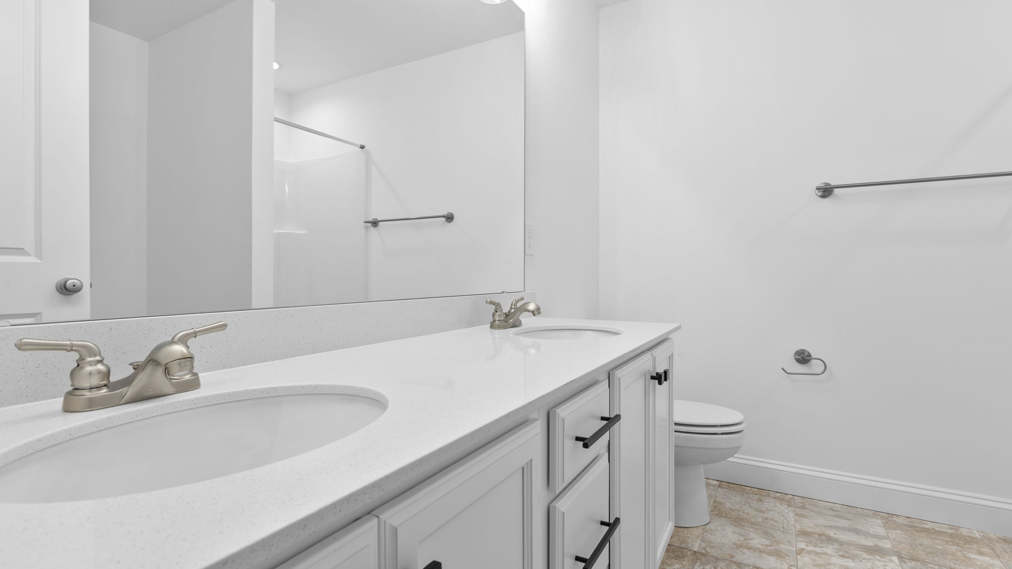 Primary bathroom with dual sink vanity.