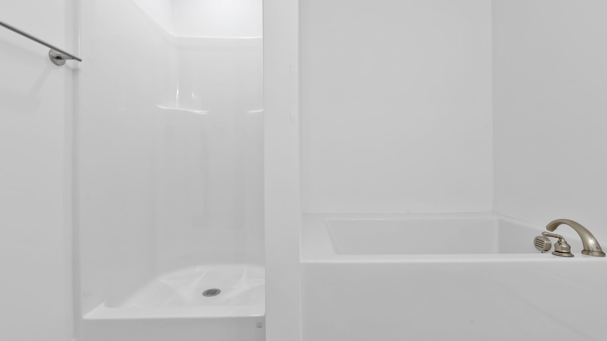 Primary bathroom with walk-in shower and garden tub.