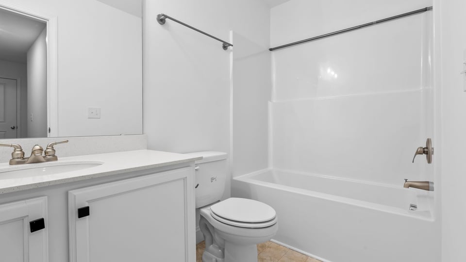 Hall bathroom with vanity and combination shower / tub.