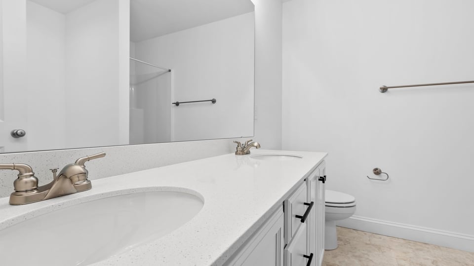 Primary bathroom with dual sink vanity.