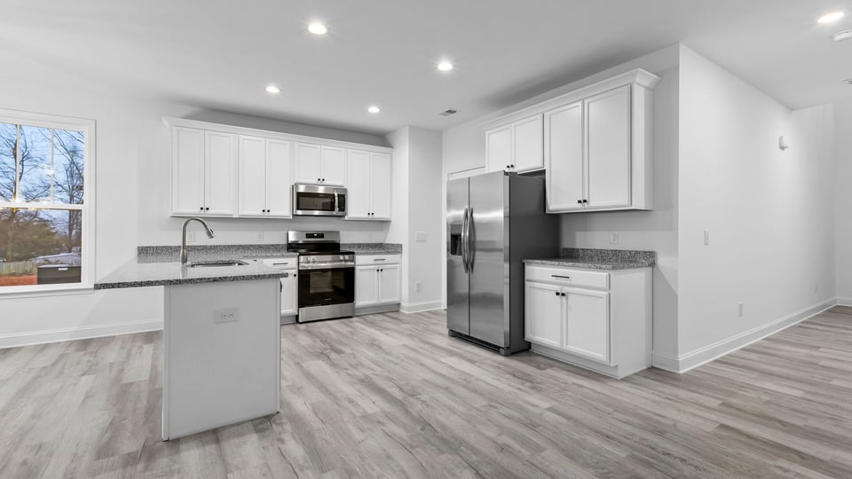 Kitchen with cabinets and window.