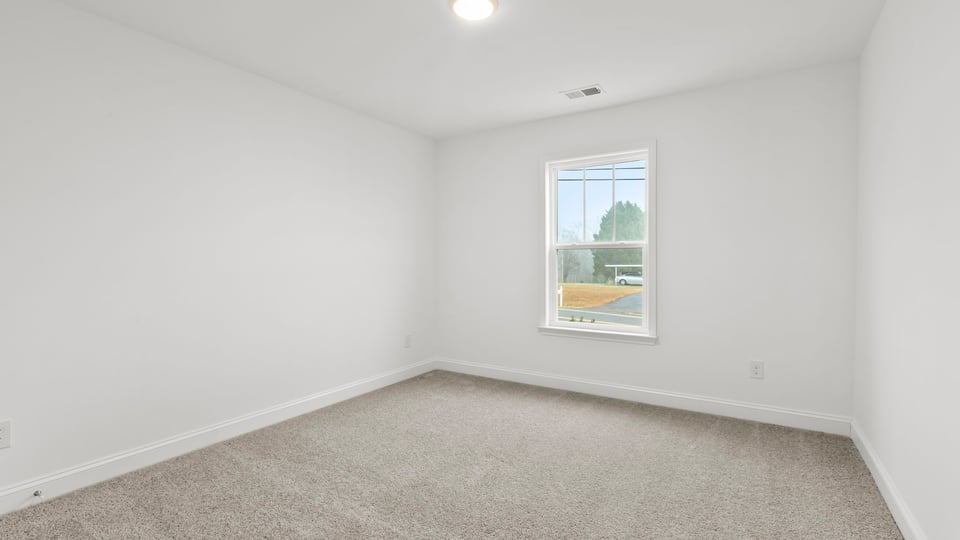 Bedroom with window and carpet.