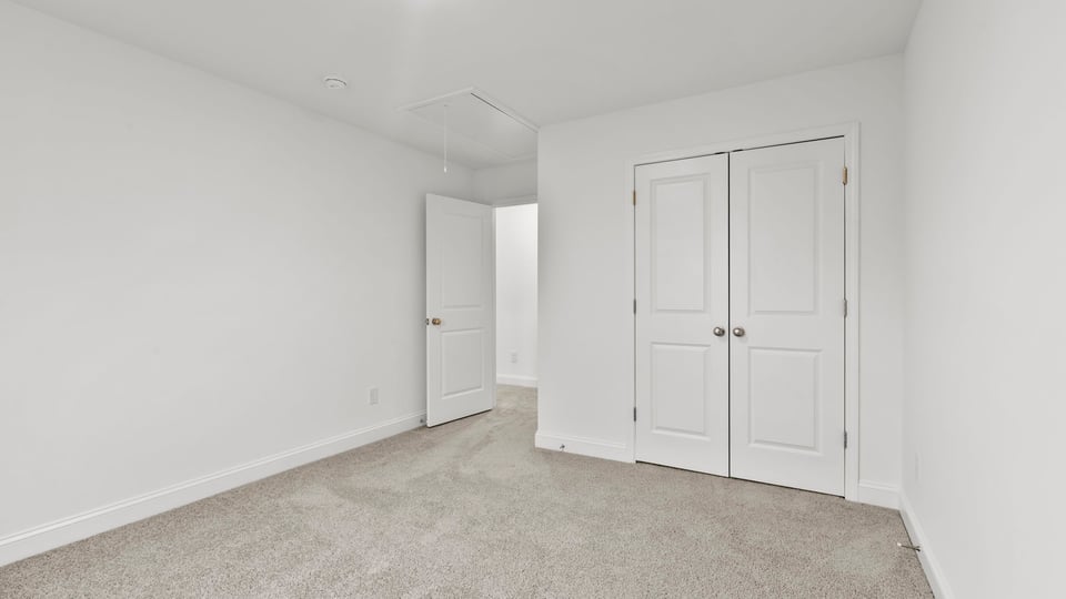 Bedroom with window and carpet.