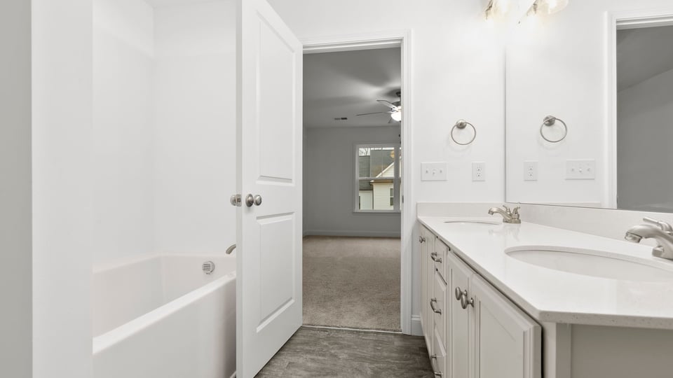 Primary bathroom with dual sink vanity.
